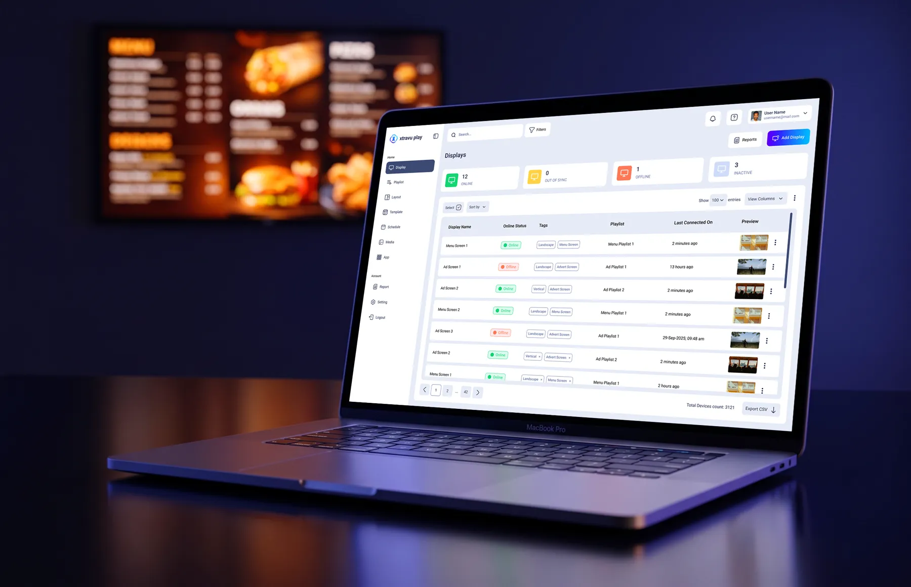 The Xtravu Play dashboard on a laptop, with a menu board behind it